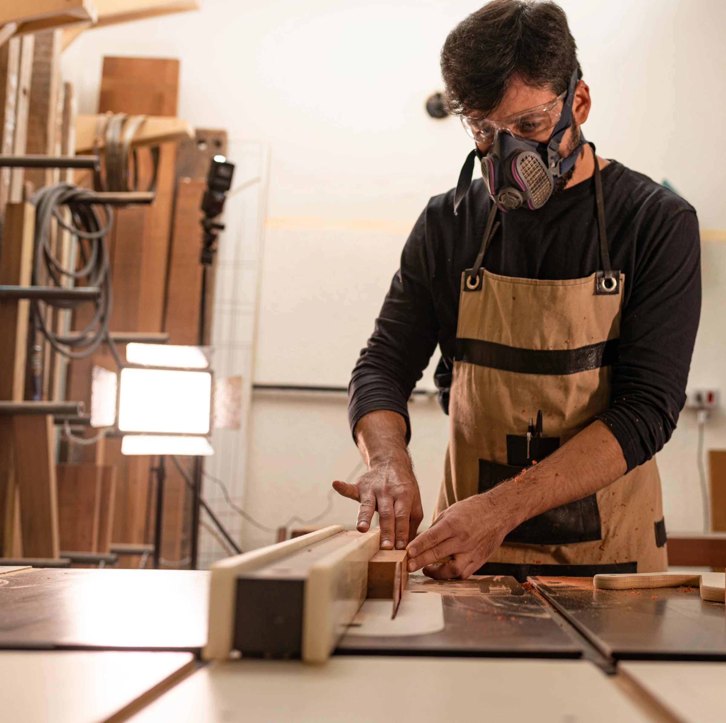 Rafael Silva working at the saw in the workshop