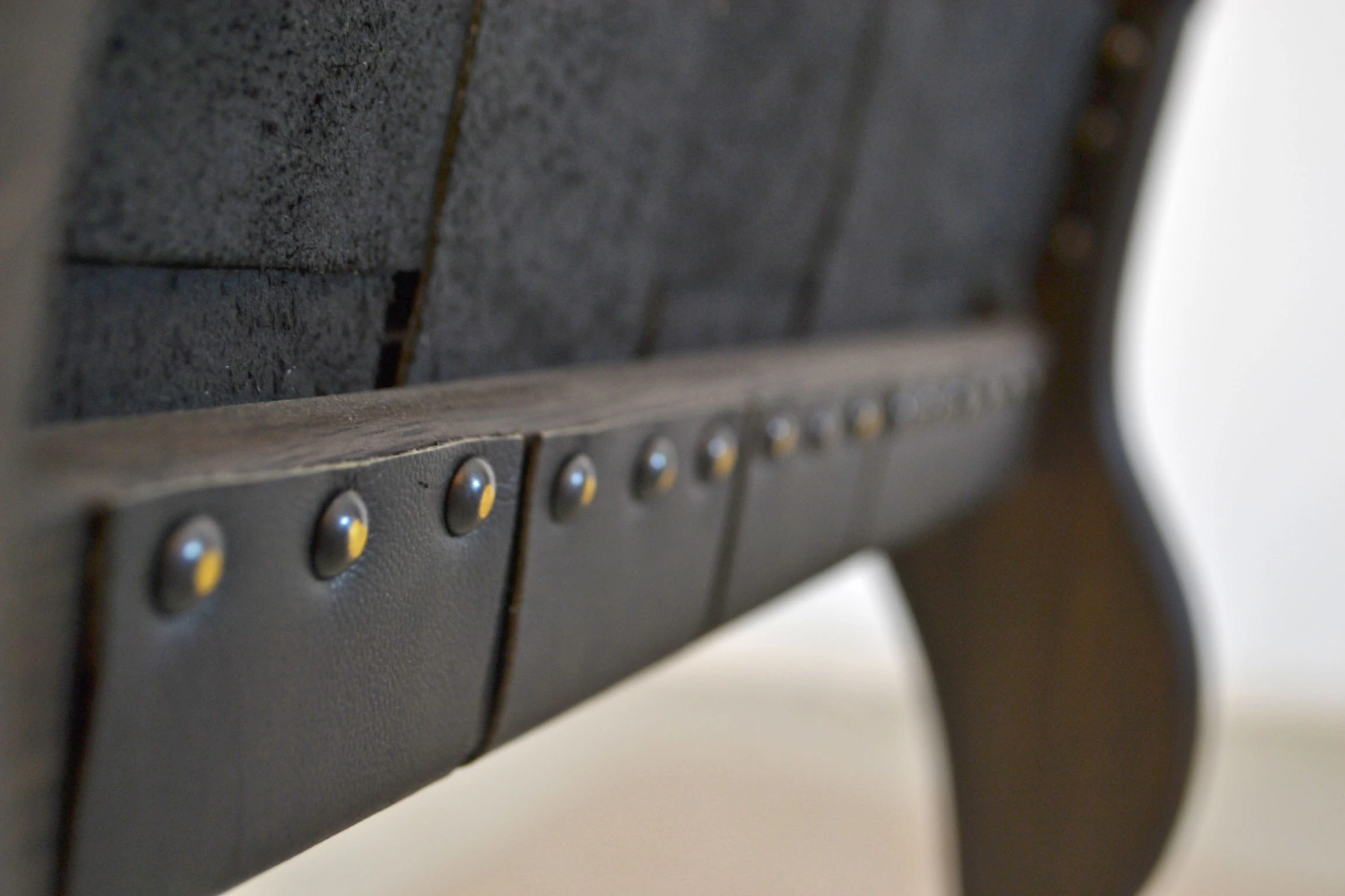 Tacks fastening the leather to the backrest rail